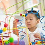 Little boy playing with an educational toy.